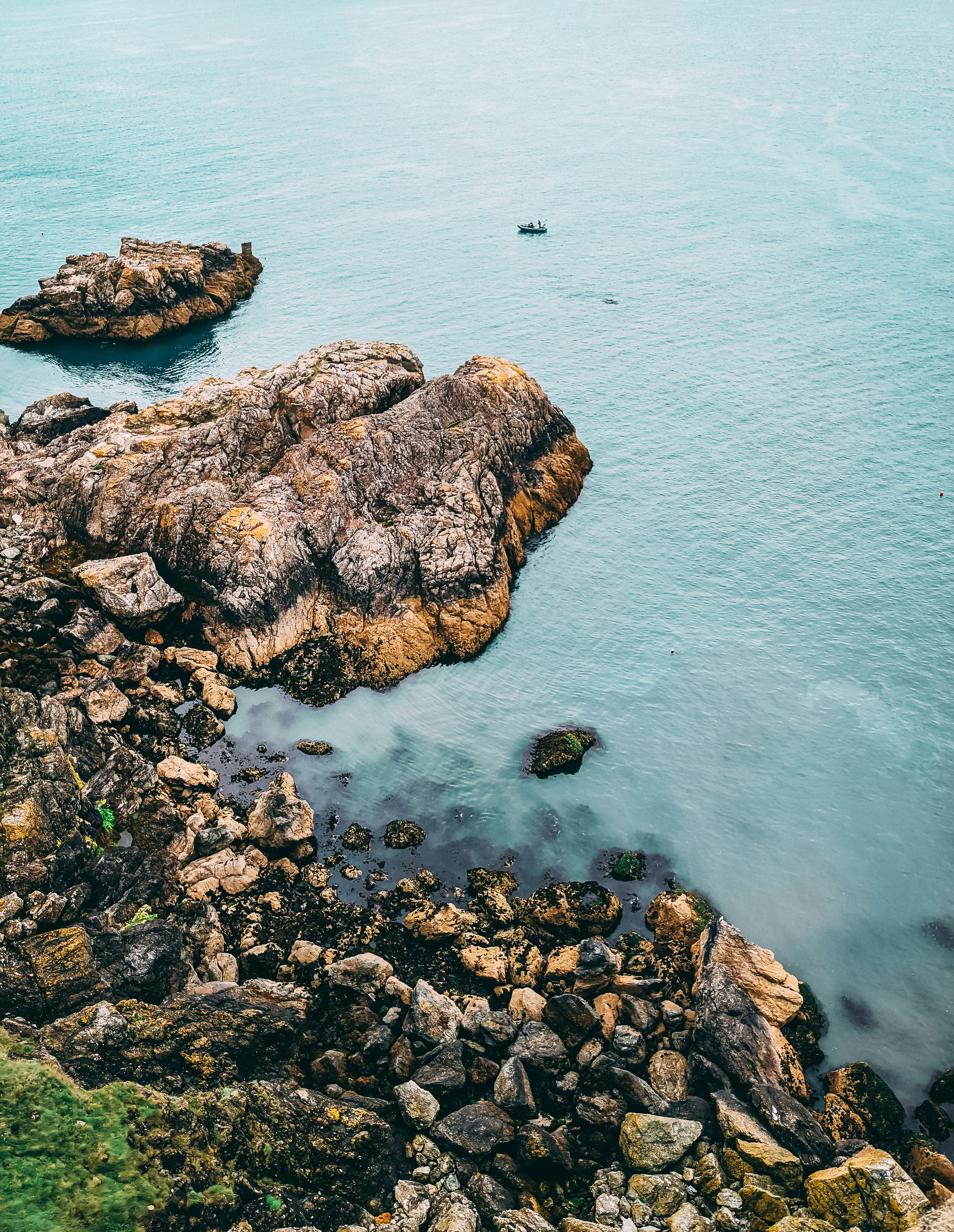 brown rock formation on sea during daytime